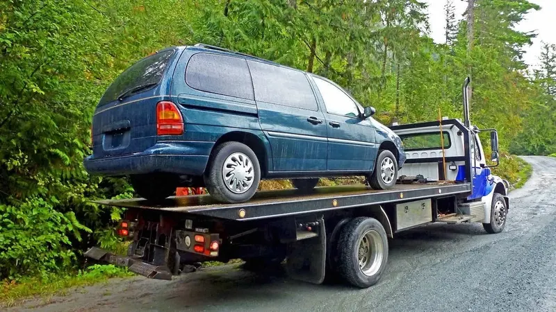 London flatbed towing a cargo van