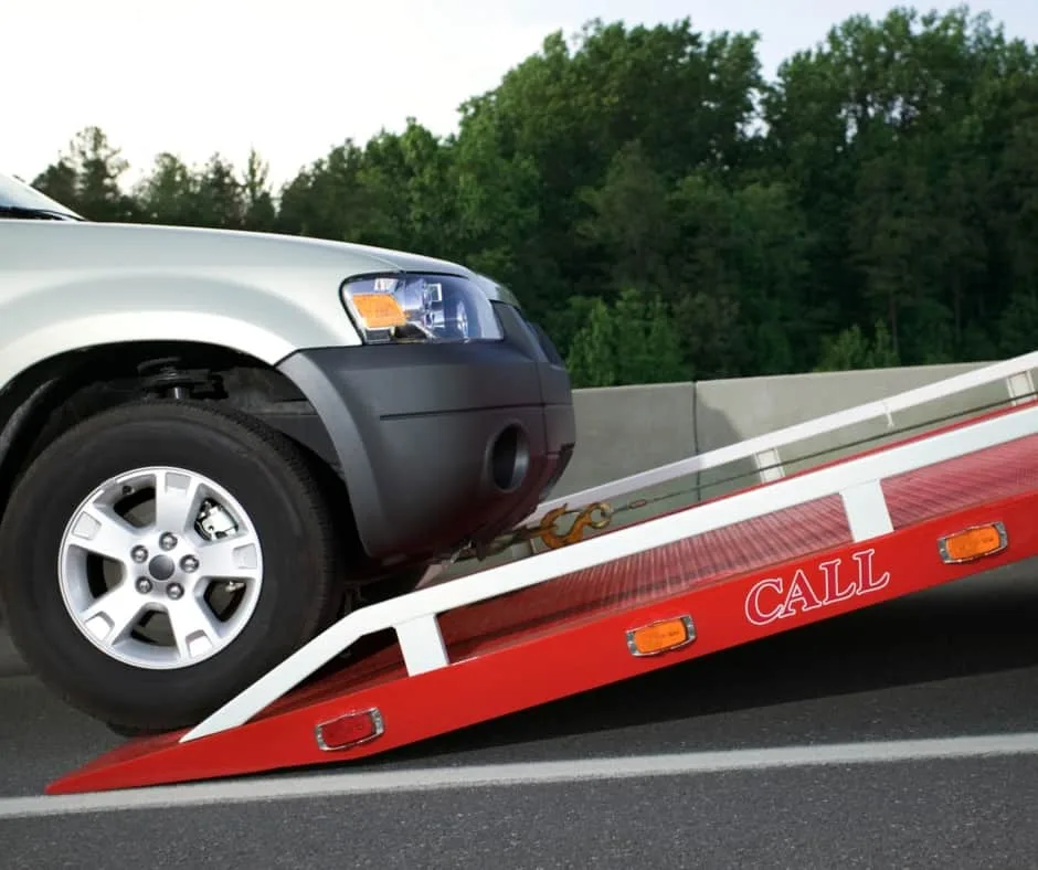 London tow truck loading a vehicle on a residential street